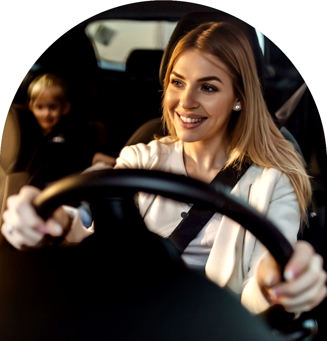 mother-smiling-driving-car-child-back-seat mother-smiling-driving-car-child-back-seat