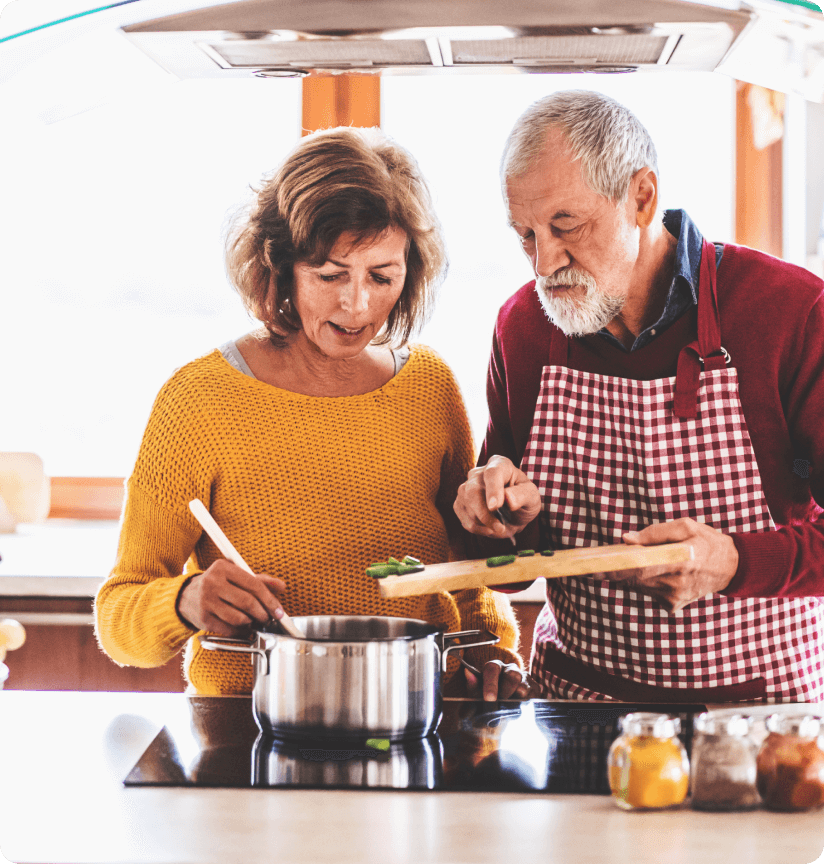 A couple cooking dinner together