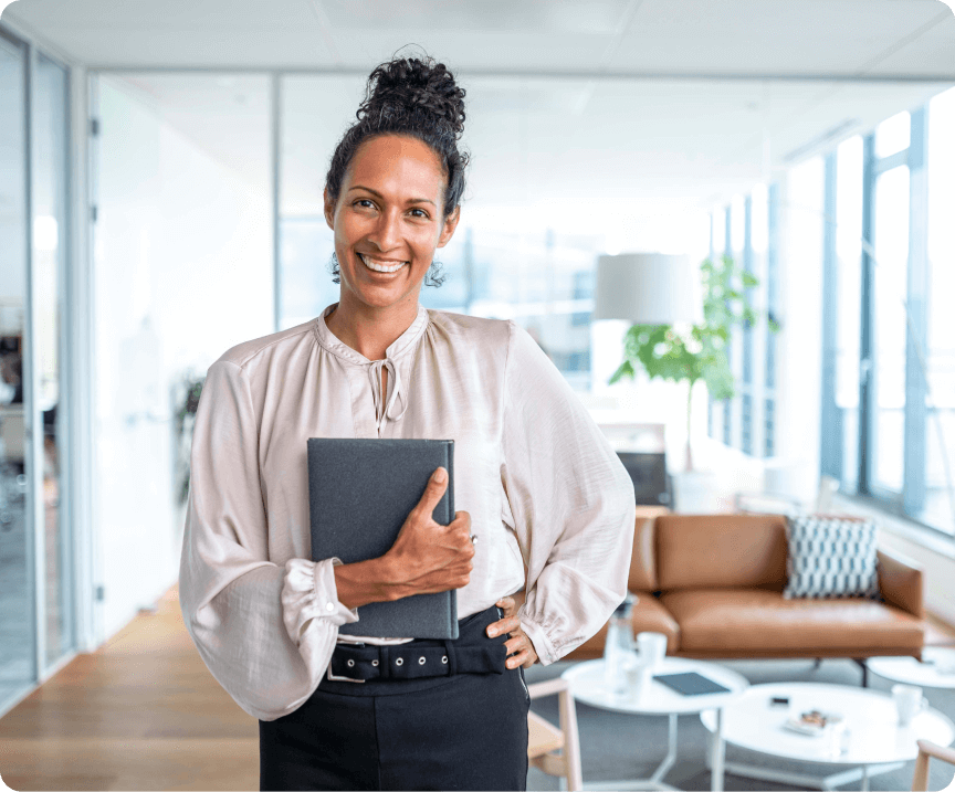 A smiling business owner holding a tablet device