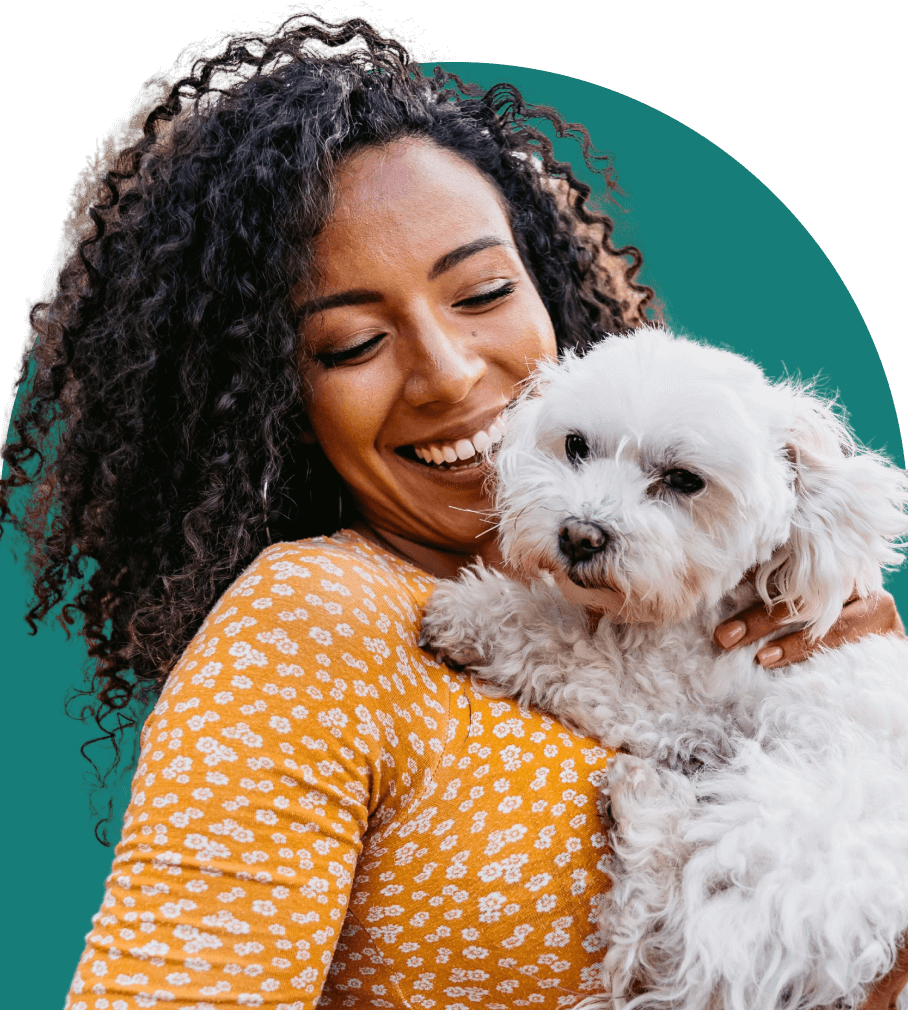 A woman holding a dog.